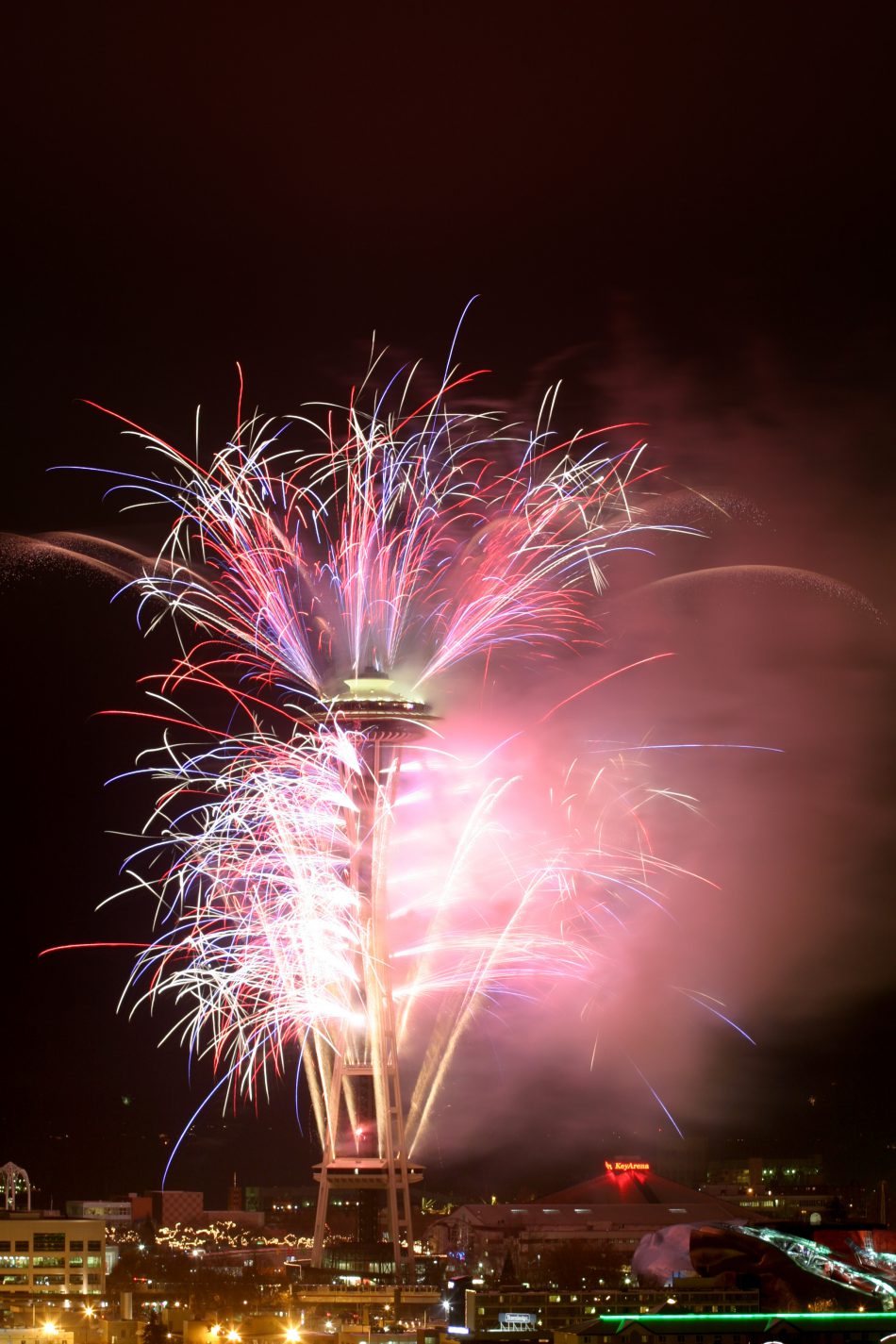 Fireworks launched from the Seattle Space Needle at night in celebration of the 2004 New Year's Day, Seattle, Washington